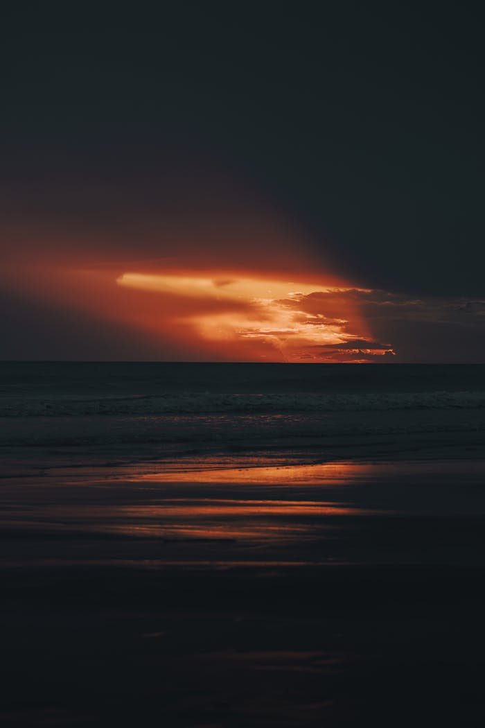 A sunset over the ocean with a black and white photo